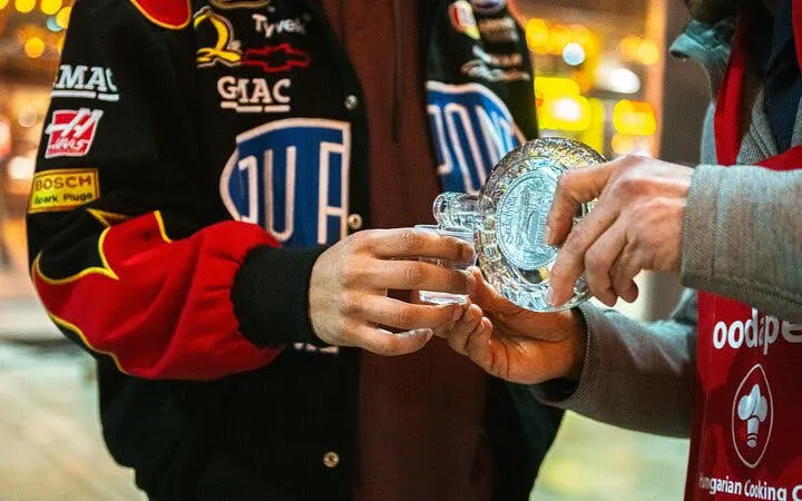 Two people exchanging a glass during Budapest food tour with local guide.