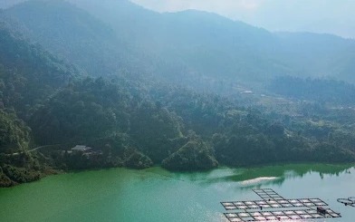 Sapa mountain landscape with green lake and floating platforms, Vietnam.