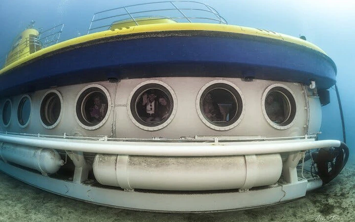 Submarine underwater with visible portholes during Tenerife tour.