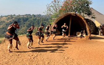 Zulu dancers performing outside a traditional hut in Durban, South Africa.