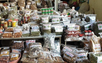Market stall with various packaged spices and herbs in Sapa, Vietnam.