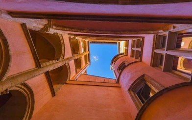 Lyon traboule courtyard view with blue sky, part of self-guided audio walking tour.