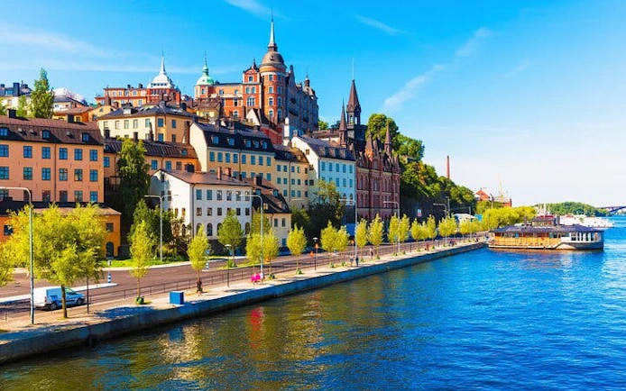 Colorful buildings along Stockholm waterfront on a sunny day, viewed during a walking tour.