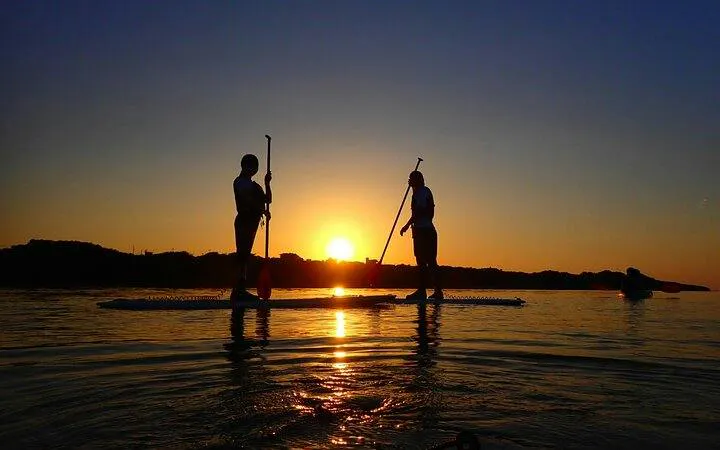 Paddleboarders at sunset on Ishigaki Island, Okinawa.