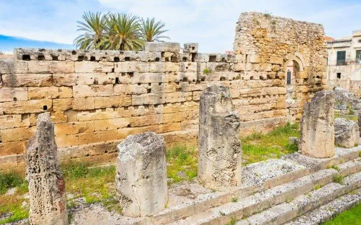 Ancient stone ruins in Siracusa, part of the Syracuse self-guided walking tour on mobile app.