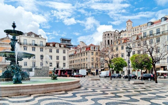 Lisbon city square with fountain and historic buildings on a private full-day tour.