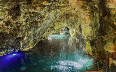 Cenote with cascading water inside a cave, part of the Punta Cana adventure tour.