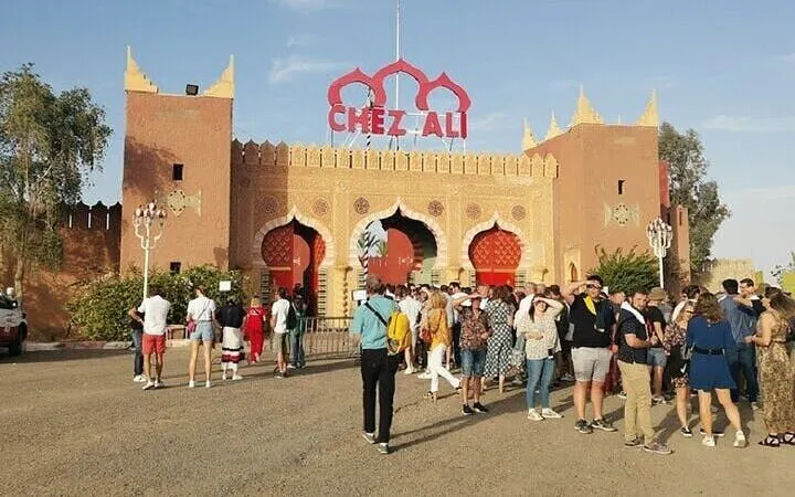 Crowd gathers outside Chez Ali entrance for Fantasia Night in Marrakesh.