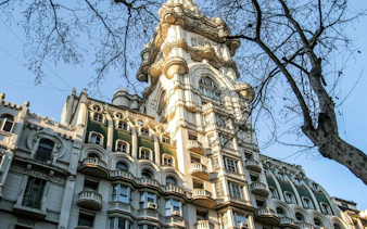 Palacio Barolo's ornate facade on Avenida de Mayo, Buenos Aires, seen during a self-guided audio tour.