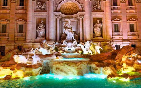 Trevi Fountain illuminated at night, featured in Rome self-guided walking tour app.