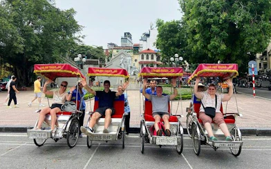 Tourists on cyclos in Hanoi's Old Quarter near Train Street.