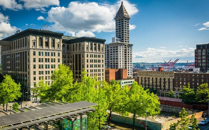 Seattle skyline featuring Smith Tower during Gold Rush city exploration game.