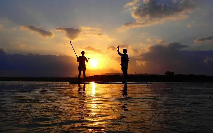 Paddleboarders at sunset on Ishigaki Island, Okinawa.