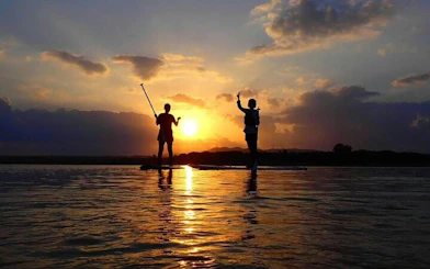 Paddleboarders at sunset on Ishigaki Island, Okinawa.