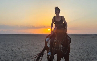 Horseback rider at sunrise in desert near Red Sea, Hurghada.