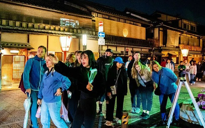 Group exploring Kyoto's Gion district at night with a local guide.