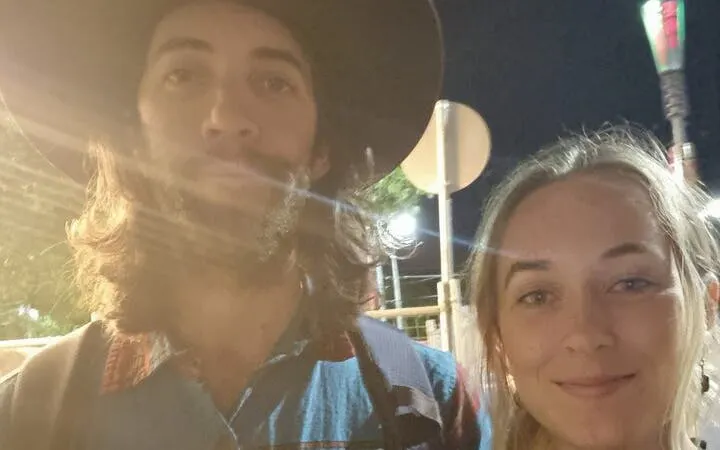 Two people exploring Melbourne at night during a self-guided city game.