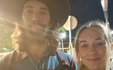 Two people exploring Melbourne at night during a self-guided city game.