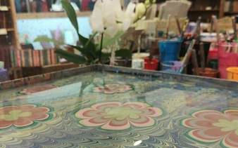 Artisan workshop in Florence with marbled paper design demonstration.