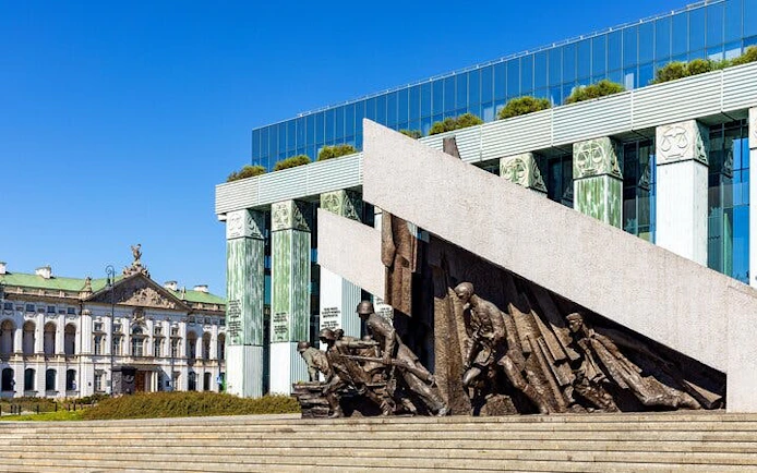 Warsaw Uprising Monument with Supreme Court building in Muranów district.