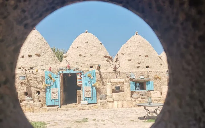 Stone beehive houses with blue doors in Harran, Turkey, part of Cappadocia and Mesopotamia tour.