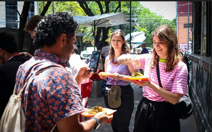 Group enjoying tacos on a street food tour in Mexico City.