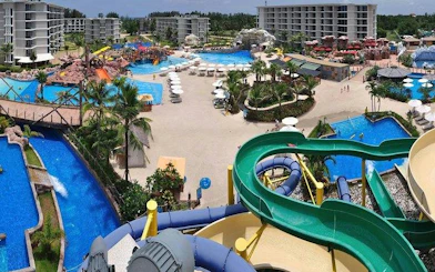 Splash Jungle Water Park in Phuket with slides, pools, and surrounding resort buildings.