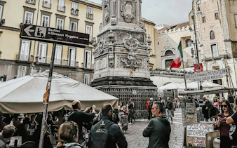 Crowd at Spaccanapoli near historic monument in Naples Historic Center, Italy.
