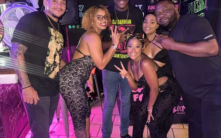 Group enjoying Sint Maarten Party Bus Nightlife Tour with bar stops and complimentary shots.
