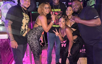 Group enjoying Sint Maarten Party Bus Nightlife Tour with bar stops and complimentary shots.