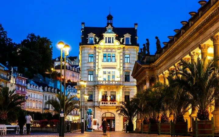 Karlovy Vary illuminated building and colonnade at dusk on self-guided walking tour.