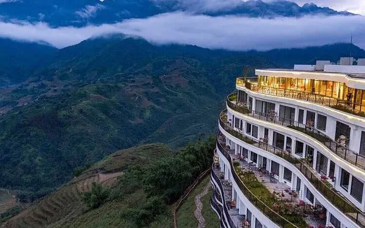 Hotel overlooking Sapa mountains on private car tour to Lonely Tree, Heaven's Gate, and Glass Bridge.