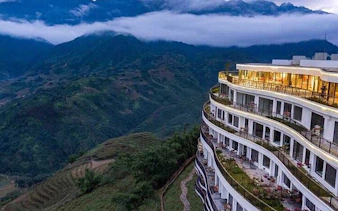 Hotel overlooking Sapa mountains on private car tour to Lonely Tree, Heaven's Gate, and Glass Bridge.