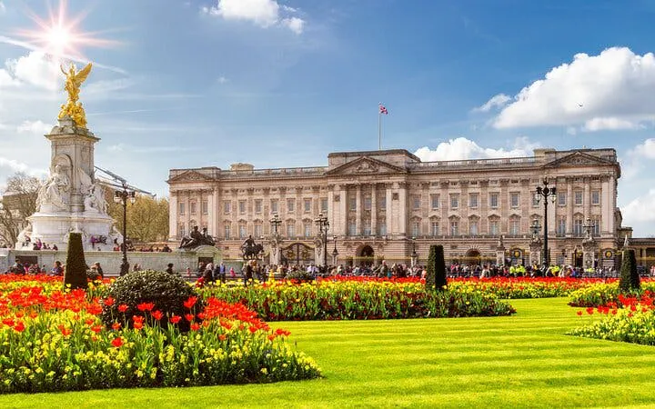 Buckingham Palace with Victoria Memorial and gardens, London, during Changing of the Guard tour.