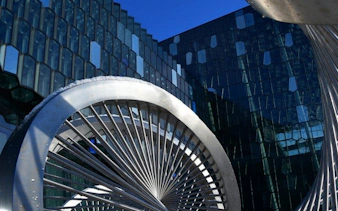Modern architecture of Harpa Concert Hall in Reykjavik during guided walking tour.