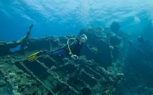 Diver exploring shipwreck in Hurghada waters during professional dive trip.
