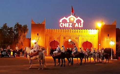 Chez Ali entrance with riders on horses at Fantasia folklore show, Marrakesh.