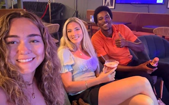 Group enjoying drinks on Sint Maarten party bus nightlife tour with bar stops.
