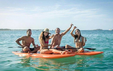 Group enjoying paddleboarding on clear waters during Punta Cana adventure tour.