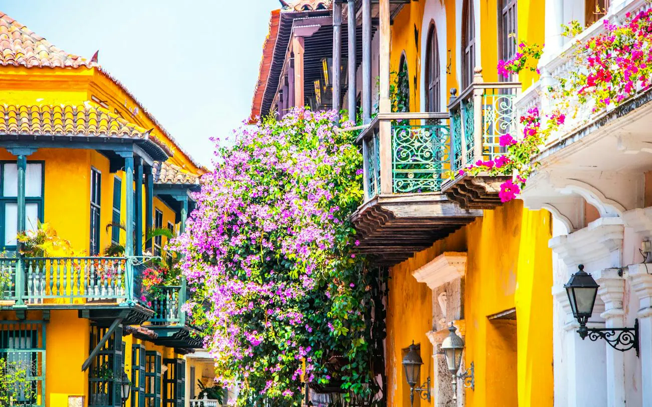 Colorful colonial balconies with flowers in Cartagena Walled City, Colombia.