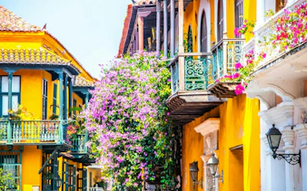 Colorful colonial balconies with flowers in Cartagena Walled City, Colombia.