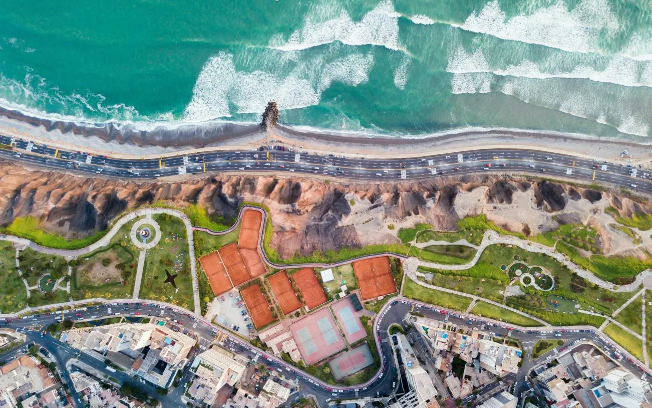 Aerial view of Miraflores coastline, featuring Kennedy Park, Larcomar, and Parque del Amor in Lima.