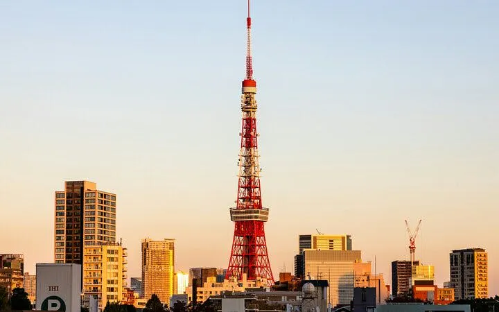Tokyo Tower at sunset with city skyline in the background.