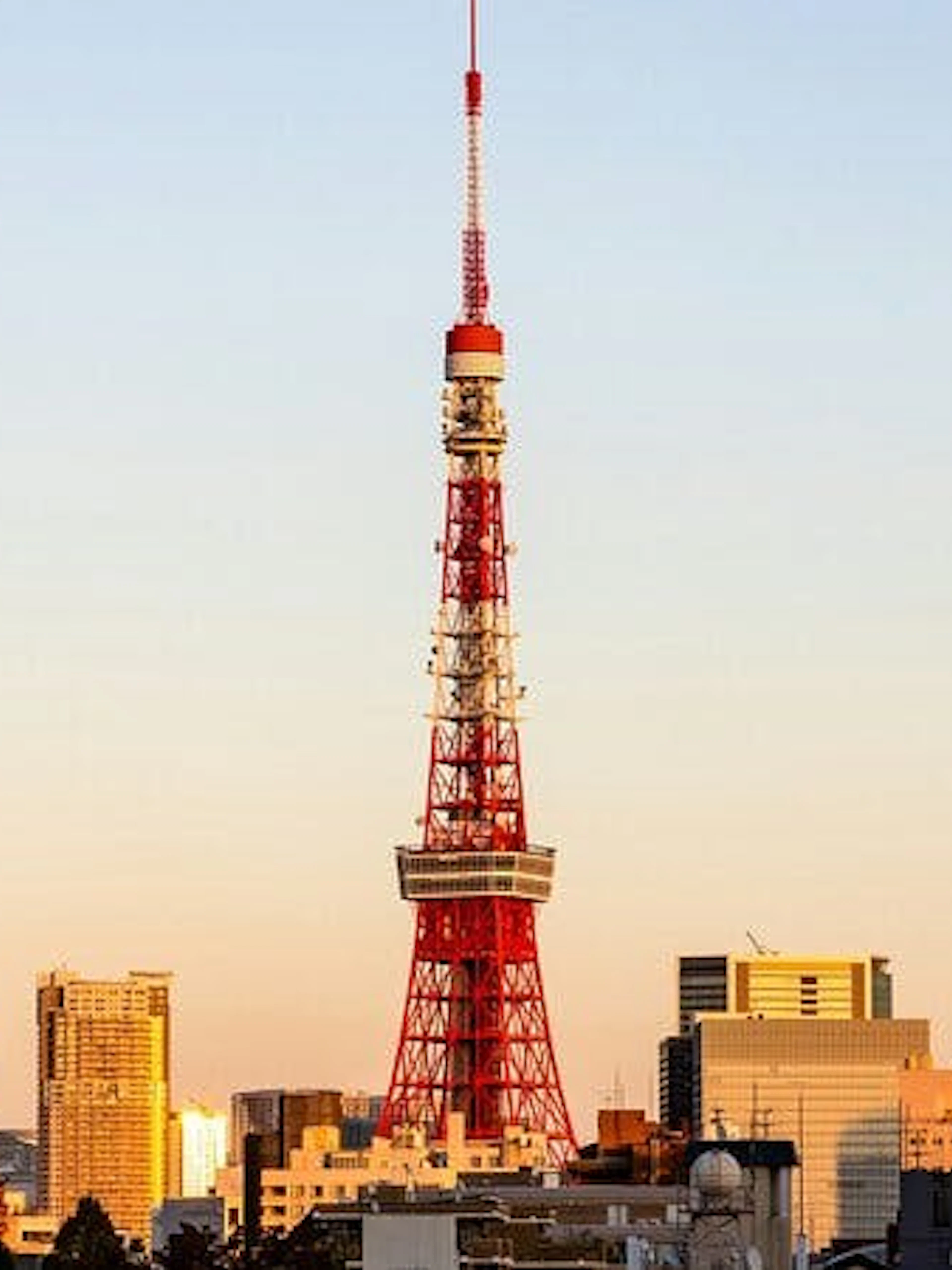 Tokyo Tower at sunset with city skyline in the background.