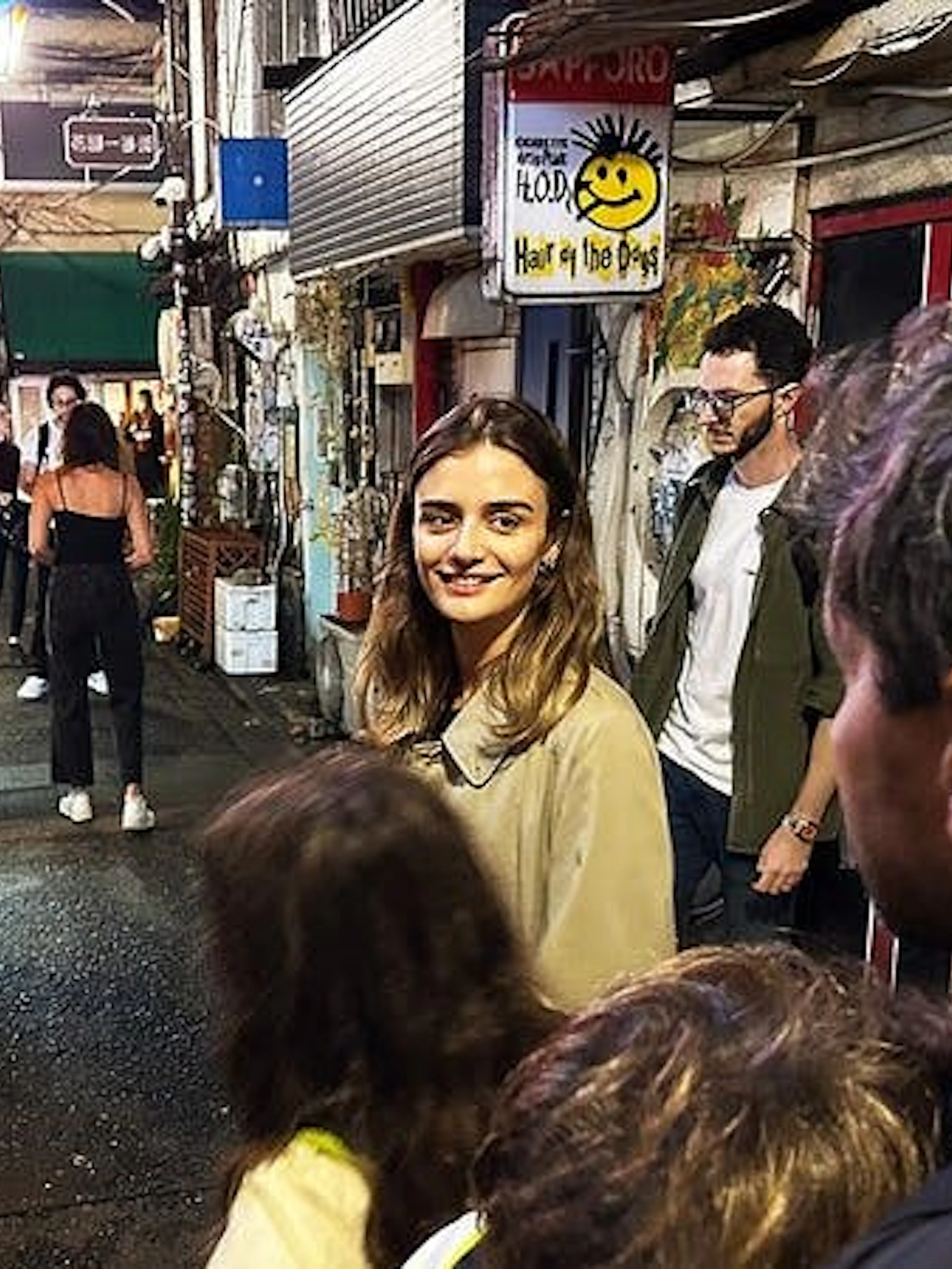 Shinjuku alley with tourists exploring nightlife and hidden bars in Tokyo.