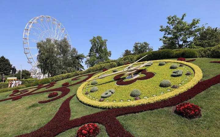 Geneva Flower Clock with Ferris wheel in background during self-guided city exploration game.