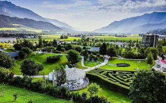 Aerial view of Swarovski Crystal Worlds garden with mountains in Innsbruck, Austria.