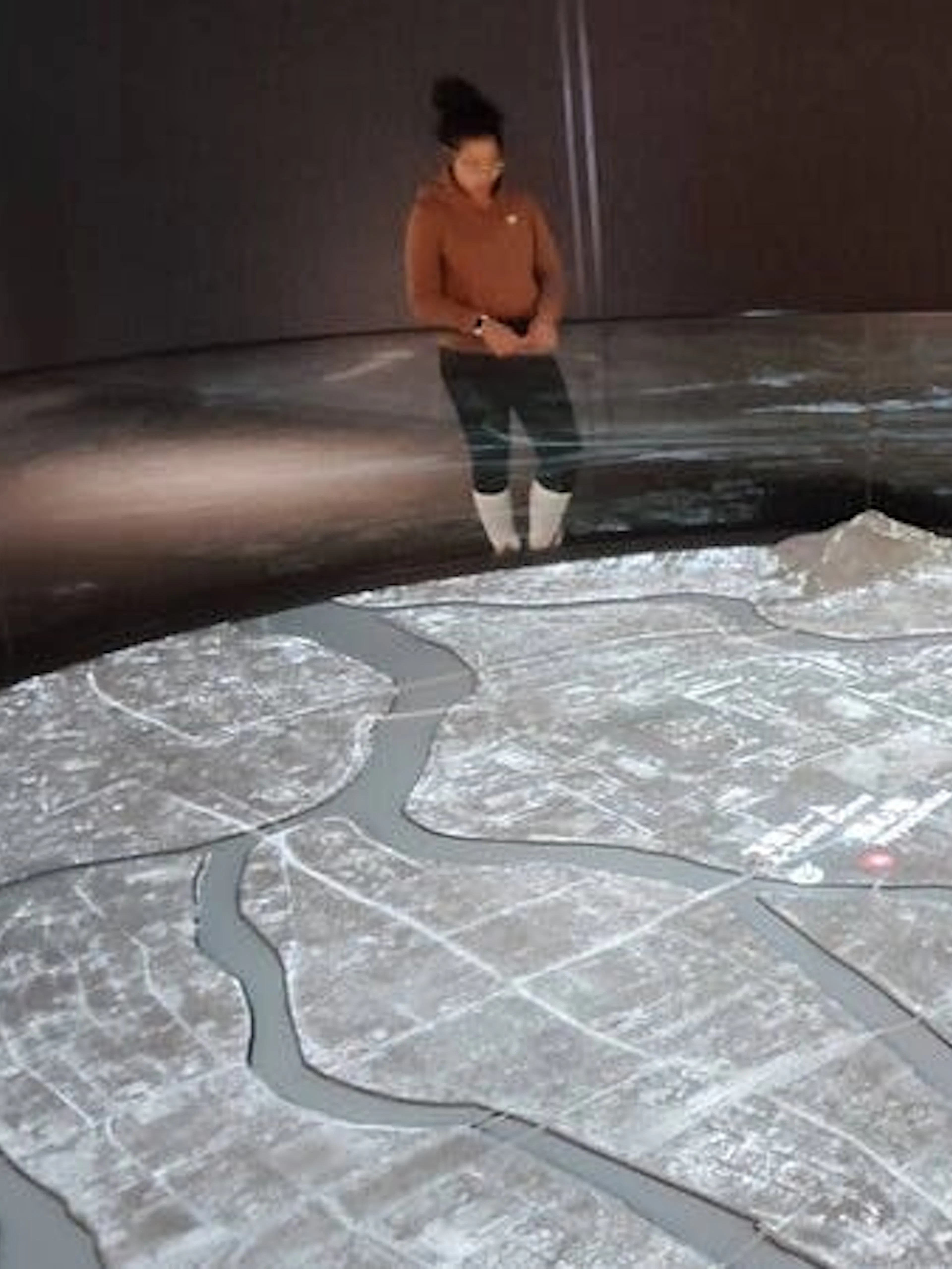 Hiroshima Peace Memorial Museum visitor observing city map exhibit.