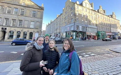 Group exploring Edinburgh street during self-guided city game.