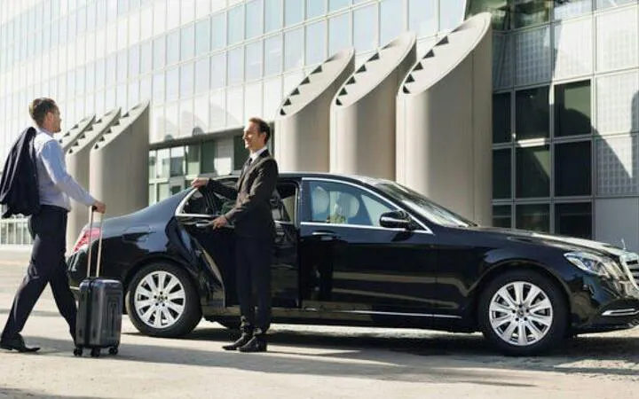 Businessman entering private car for transfer between Sharm El Sheikh and Nuweibaa City.